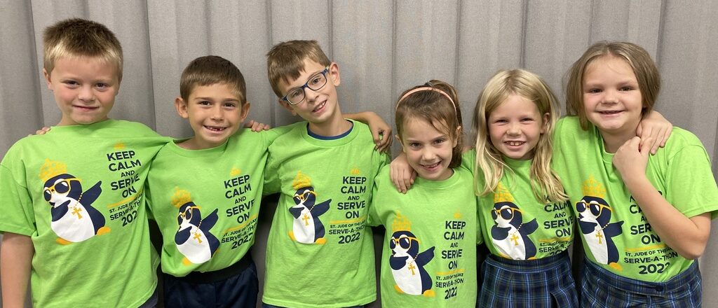 students smile at the camera in their school service T-shirts at the top-rated catholic elementary catholic school in mahtomedi